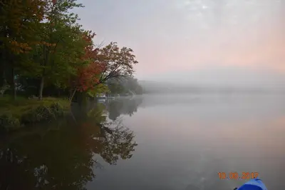 a foggy river with trees on the side of it at Domaine Henri-Daze in Saint-Pierre-Baptiste