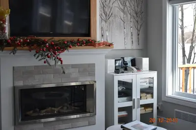 a fireplace with a christmasreath on top of it at Domaine Henri-Daze in Saint-Pierre-Baptiste