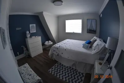 a bedroom with a large bed and a window at Domaine Henri-Daze in Saint-Pierre-Baptiste