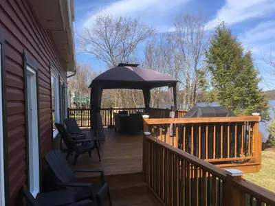 a deck with a gazebo on a house at Domaine Henri-Daze in Saint-Pierre-Baptiste