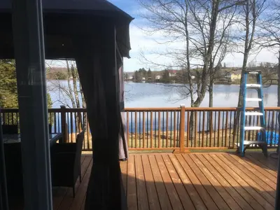 a view of a porch with a view of a lake at Domaine Henri-Daze in Saint-Pierre-Baptiste