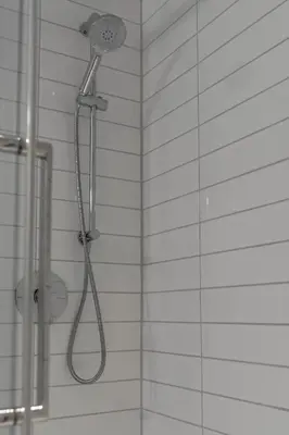 a shower with a shower head in a bathroom at Hotel Le Victorin, an Ascend Hotel Collection Member in Victoriaville