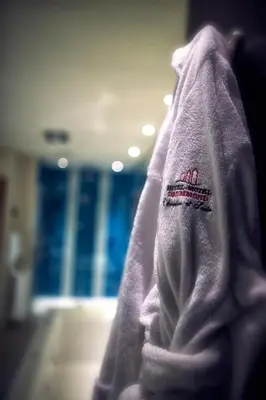 a purple towel with a red logo on it at Hotel-Motel Drummond in Drummondville