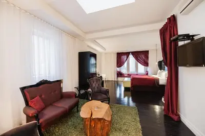 a living room with a couch and a table at Hotel Chez Swann in Montréal