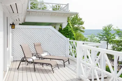 two chairs and a table on a porch at Manoir Hovey, Relais & Châteaux in North Hatley