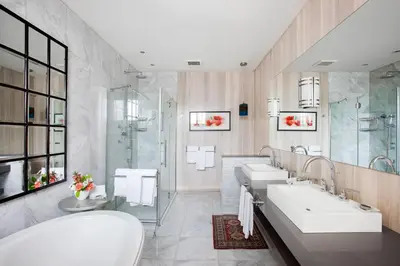 a bathroom with two sinks and a shower at Manoir Hovey, Relais & Châteaux in North Hatley