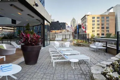 a row of white tables and chairs on a patio at DoubleTree By Hilton Montreal in Montréal
