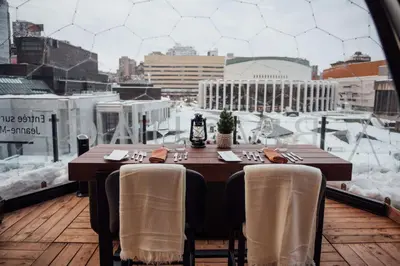 a table on a balcony with a view of a city at DoubleTree By Hilton Montreal in Montréal