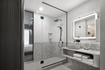 a bathroom with a shower and a sink at Hôtel Le Germain Montréal in Montréal