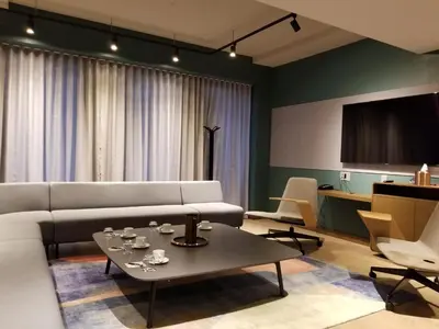 a living room with a white couch and a table at Hôtel Le Germain Montréal in Montréal
