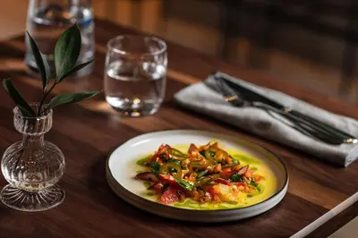 a plate of food on top of a wooden table at Hôtel Le Germain Montréal in Montréal