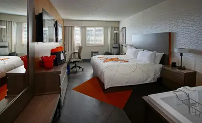 a hotel room with a large bed and a bathroom at Auberge Godefroy in Bécancour
