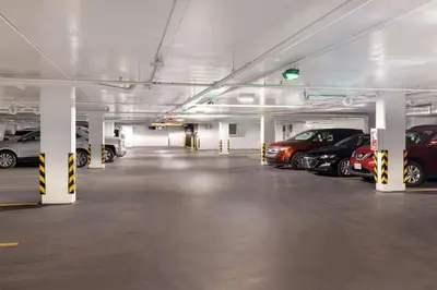 a parking garage filled with lots of parked cars at Home2 Suites By Hilton Montreal Dorval in Dorval