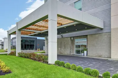 a building with awning on the side of it at Home2 Suites By Hilton Montreal Dorval in Dorval