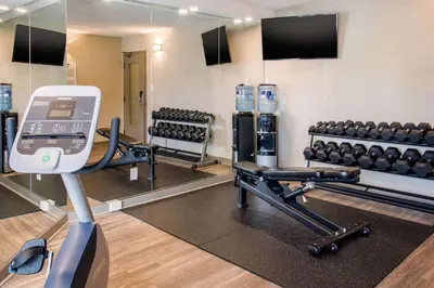 a fitness room with a gym with a mirror at Comfort Inn Aeroport in Dorval
