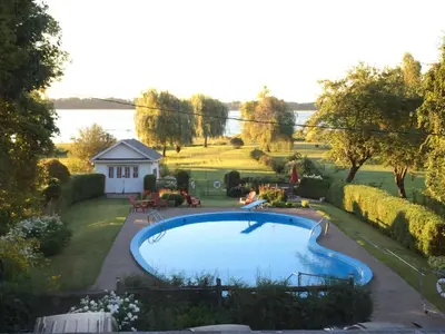 a swimming pool in a yard next to a house at Gîte Saint-Laurent in Trois-Rivières