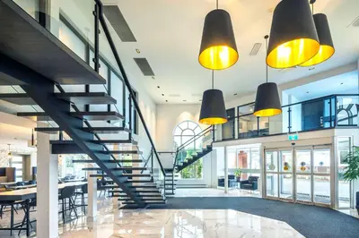 a staircase in a building with yellow lights at Les Suites de Laviolette, an Ascend Collection Hotel in Trois-Rivières