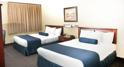 a hotel room with two beds and a window at Hotel Days Inn Blainville & Centre de Conférence in Blainville