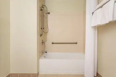 a bathroom with a shower and a white bath tub at Hotel Days Inn Blainville & Centre de Conférence in Blainville