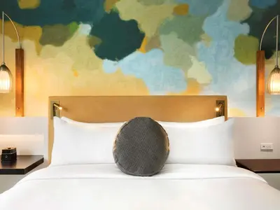 a bed with a round pillow sitting on top of it at Fairmont The Queen Elizabeth in Montréal