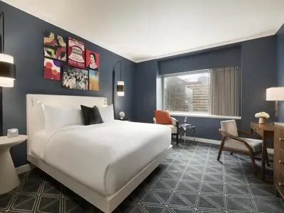 a hotel room with a bed and a desk at Fairmont The Queen Elizabeth in Montréal