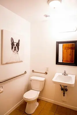 a bathroom with a toilet and a sink at Hotels Hébert in Bécancour