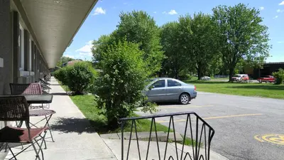 a car parked on the side of a street at Le Deauville Motel in Trois-Rivières