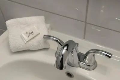 a bathroom sink with a faucet and a towel at Le Deauville Motel in Trois-Rivières
