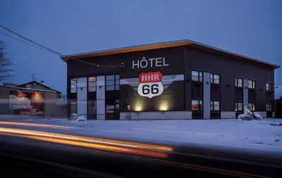 a hotel with a sign on the front of it at Hotel Historique et Manoir Route 66 in Saint-Victor
