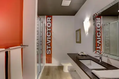 a bathroom with a sink and a toilet at Hotel Historique et Manoir Route 66 in Saint-Victor