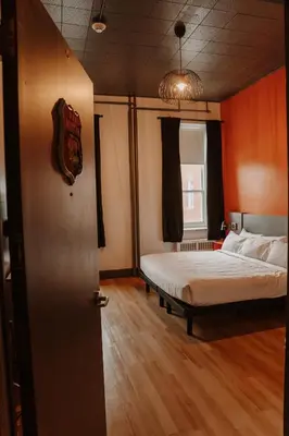 a hotel room with a bed and a window at Hotel Historique et Manoir Route 66 in Saint-Victor