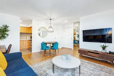 a living room with a blue couch and a table at LaCité Cozy Apartment Close to Central Montreal in Montréal