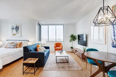 a living room with a couch and a table at LaCité Cozy Apartment Close to Central Montreal in Montréal