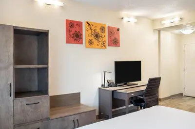 a room with a desk with a computer on a wall at Days Inn by Wyndham Berthierville in Berthierville