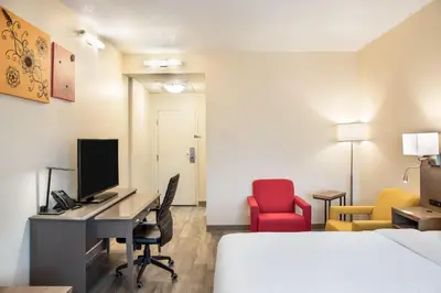 a room with a desk with a computer and a bed at Days Inn by Wyndham Berthierville in Berthierville