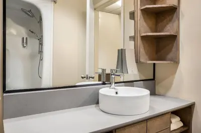 a bathroom with a sink and a shower at Days Inn by Wyndham Berthierville in Berthierville