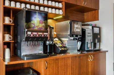 a coffee shop with a coffee machine on a counter at Days Inn by Wyndham Berthierville in Berthierville