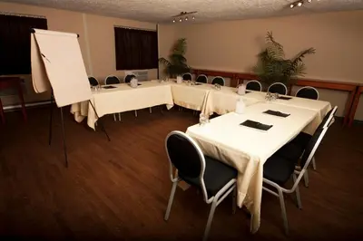a conference room with tables and chairs in it at Hotel L'Express in Longueuil