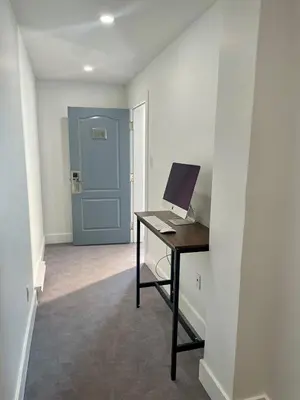 a room with a desk with a computer on it at Econo Lodge Hotel Brossard in Brossard