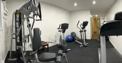 a gym with several tread machines in a room at Econo Lodge Hotel Brossard in Brossard
