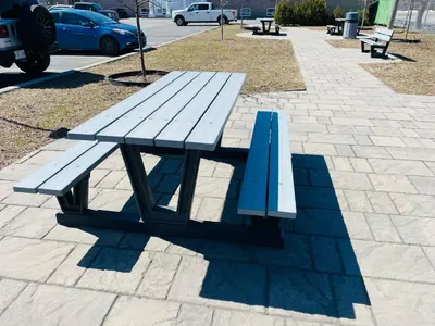 a blue picnic bench sitting on a sidewalk at Econo Lodge Hotel Brossard in Brossard
