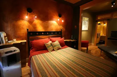 a bedroom with a bed with red pillows at A La Carte Bed & Breakfast in Montréal