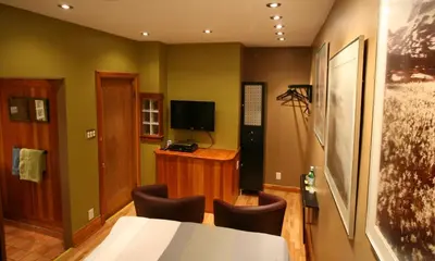a room with a table and chairs and a television at A La Carte Bed & Breakfast in Montréal