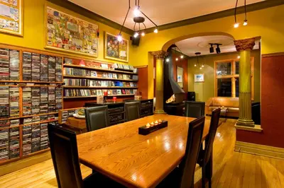 a dining room with a wooden table in a library at A La Carte Bed & Breakfast in Montréal