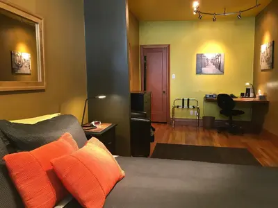 a room with a bed with orange pillows on it at A La Carte Bed & Breakfast in Montréal
