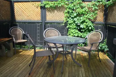 a table and chairs on a deck with a table and chairs at A La Carte Bed & Breakfast in Montréal