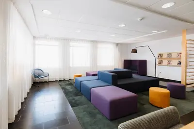 a waiting room with couches and chairs at Le Dauphin St-Hyacinthe in Saint-Hyacinthe
