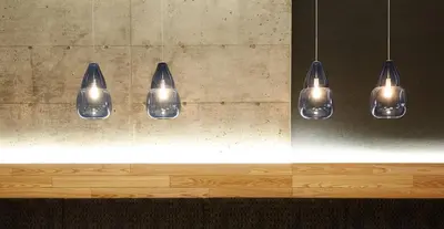 a group of five lights hanging from a wall at Le Dauphin Montréal Centre-Ville in Montréal