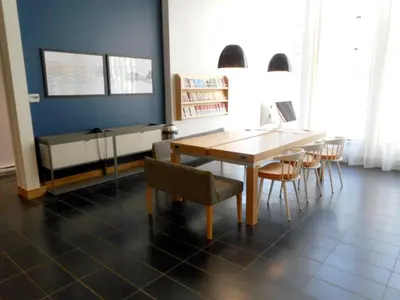 a dining room with a wooden table and chairs at Le Dauphin Montréal Centre-Ville in Montréal