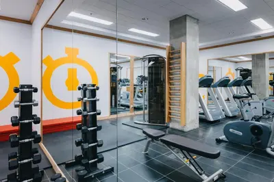 a gym with cardio equipment and a large mirror at Le Dauphin Montréal Centre-Ville in Montréal